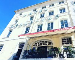 View from the outside of the façade of the Belle Vue hotel in Marseille, France, and the La Caravelle jazz bar and restaurant.